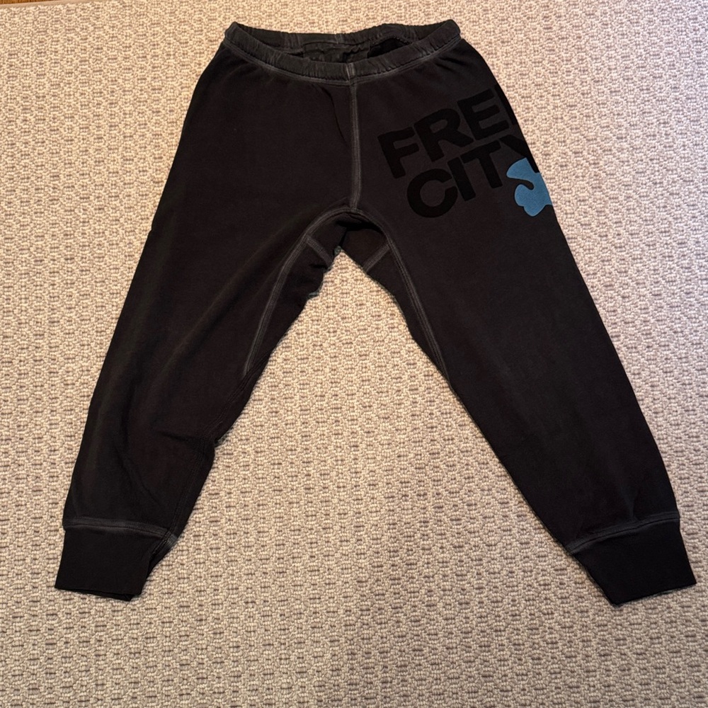 freecity women’s cropped Black Joggers with drop crotch, and blue/white Logo.
